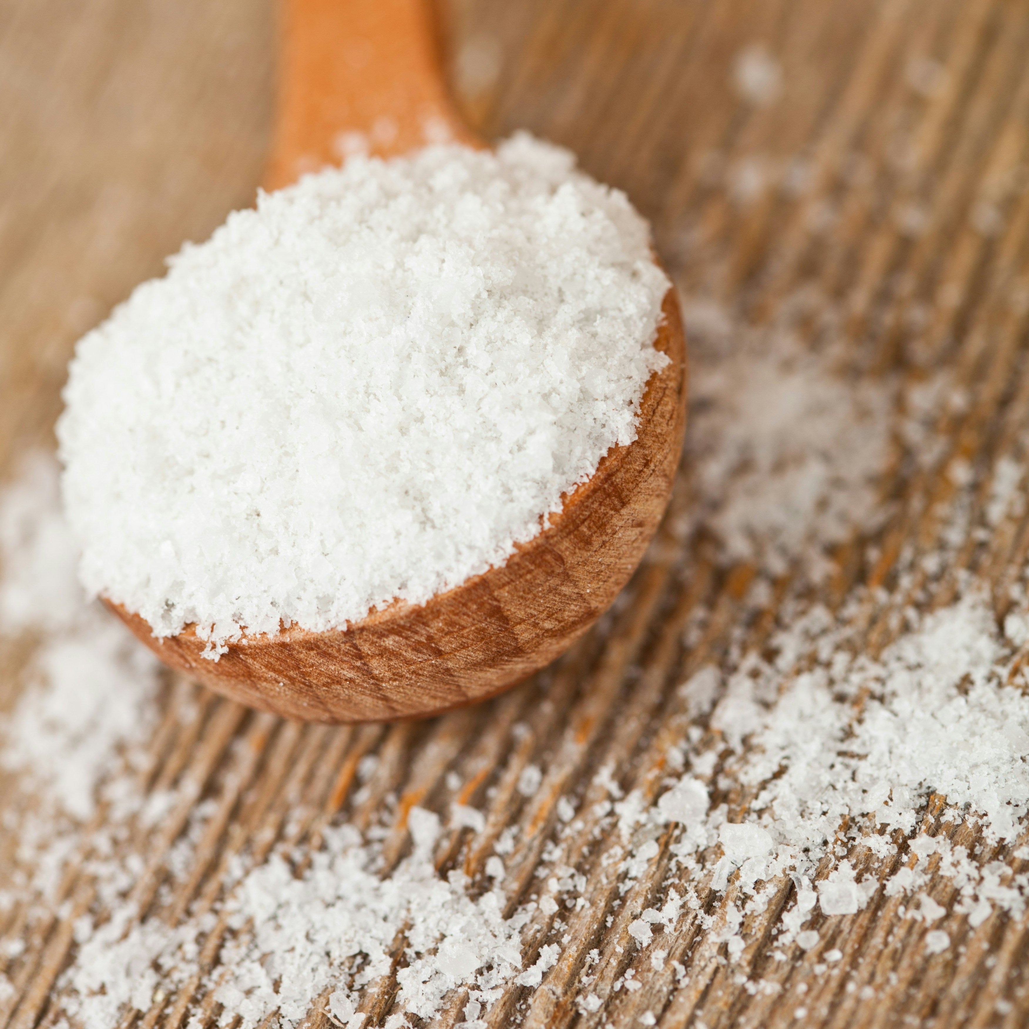 Kaolin clay is a soft, earthy, usually white mineral powder shown in a wooden spoon